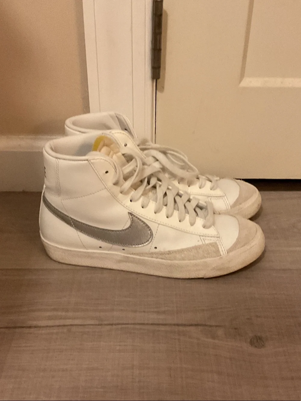 Nike Blazer Women’s White High-Top Sneakers with Silver Swoosh Accent